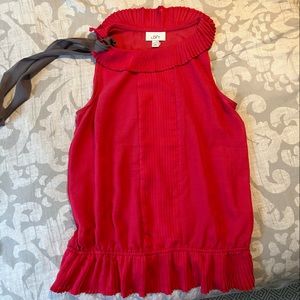 Cute top, never worn. Softer pink than in photos with gray tie!